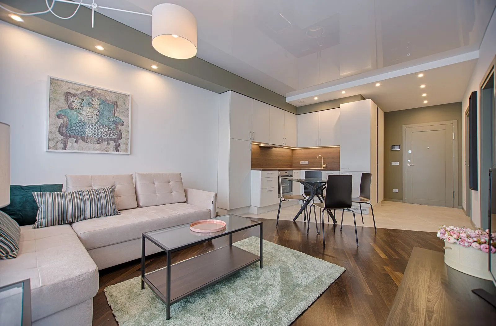 Estar de residencia contemporánea con doble altura y carpintería clara.